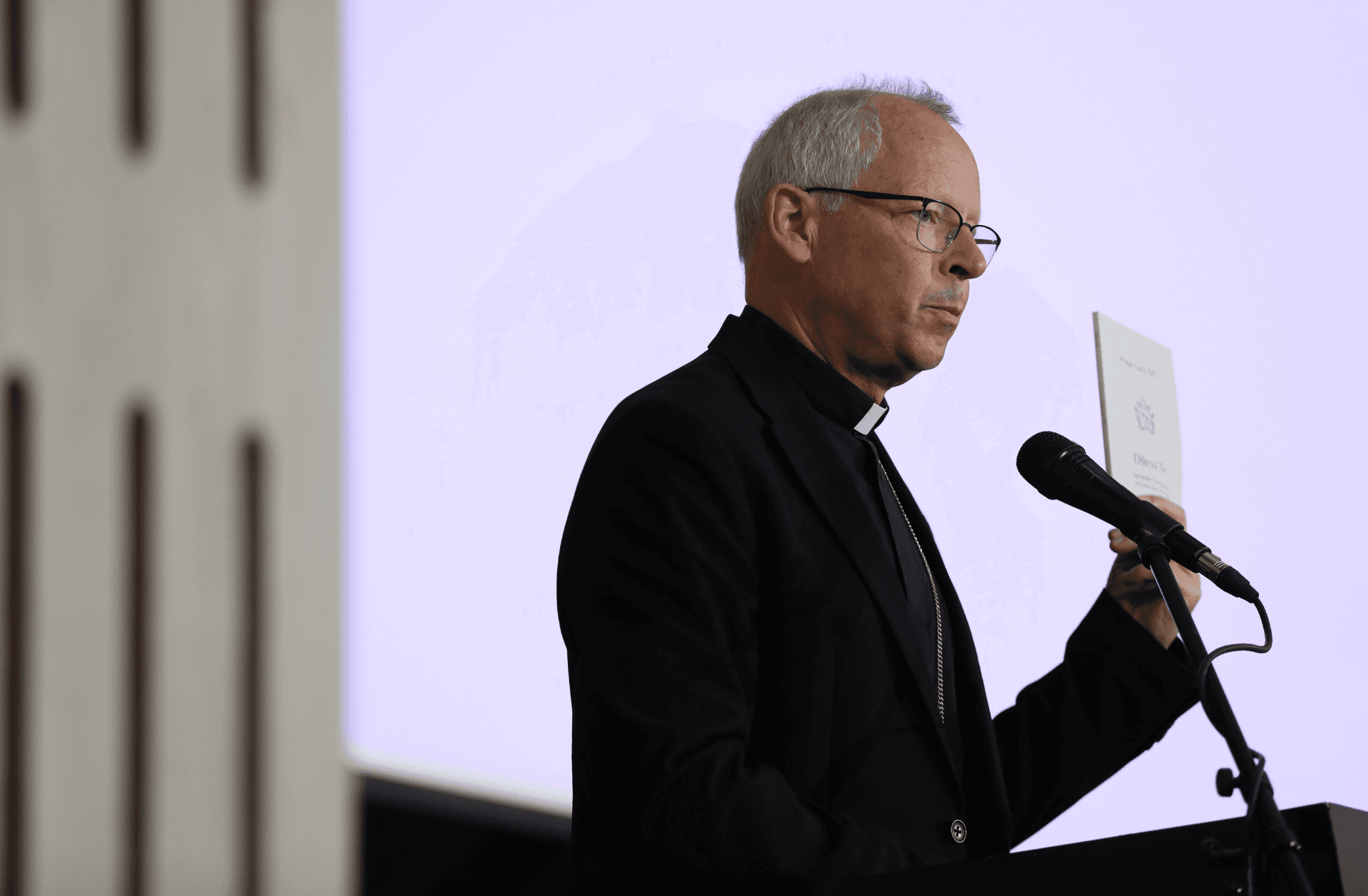 Archbishop Bert van Megen holding a copy of Dilexi Te
